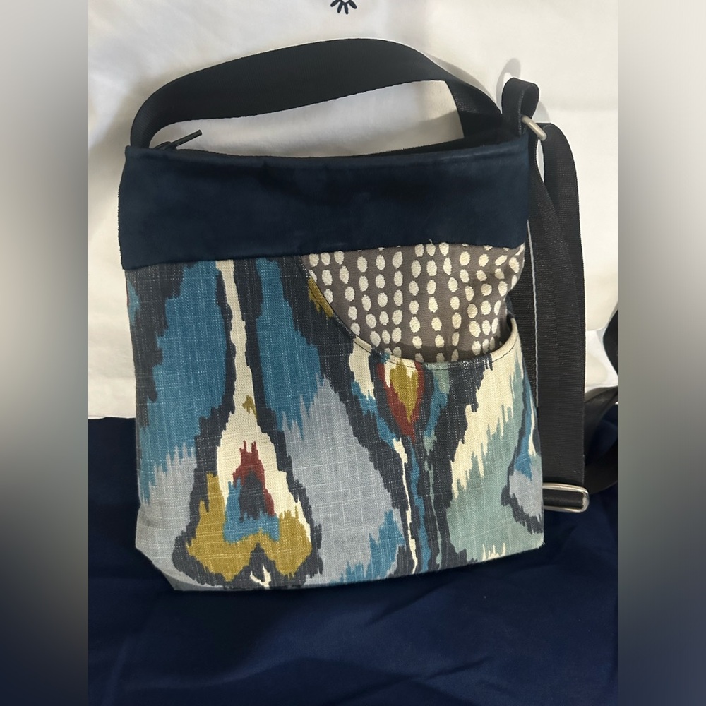 Blue crossbody purse with adjustable strap.